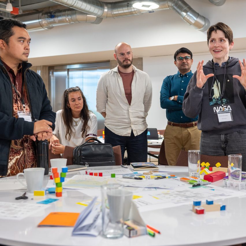 a photograph of design students around a desk