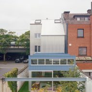 Sawtooth-roofed extension with "factory-like aesthetic" added to Ghent home