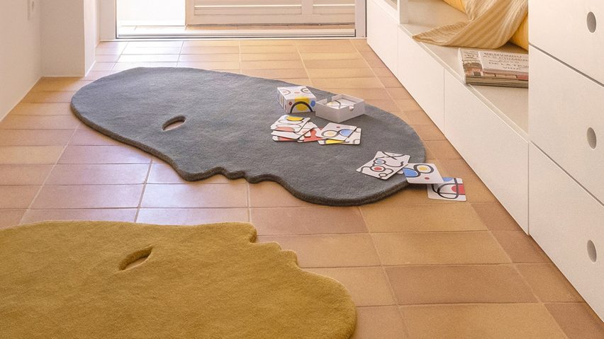 Children's bedroom with face-shaped rugs on the floor