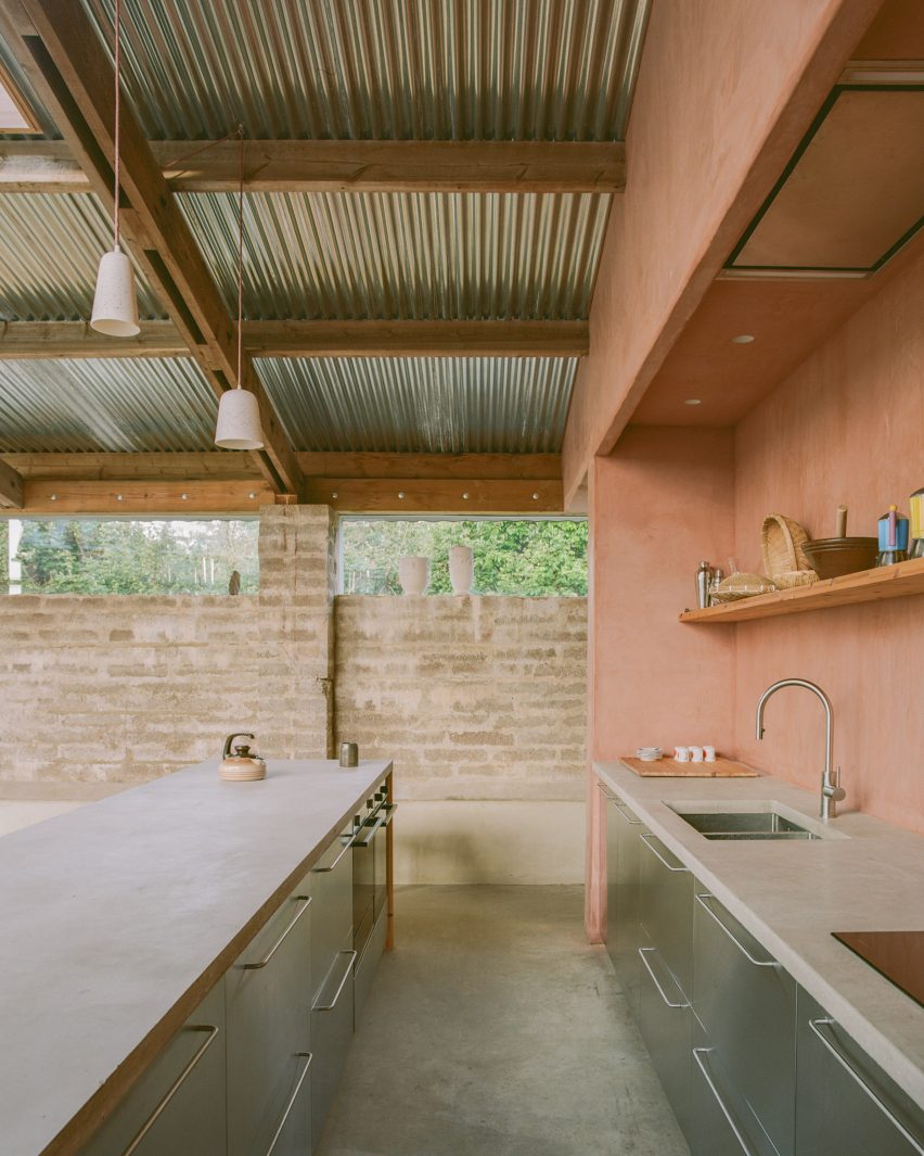 Kitchen with clay walls and concrete counters