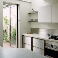 Kitchen in Stone and Steel House extension by DGN Studio and Sarah Izod