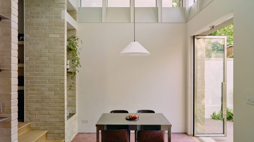 Dining table in Stone and Steel House extension by DGN Studio and Sarah Izod