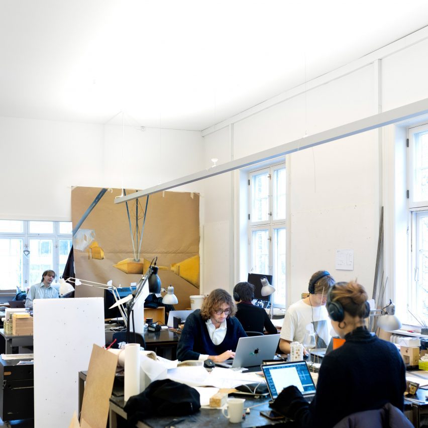 a photograph of students working together in a studio