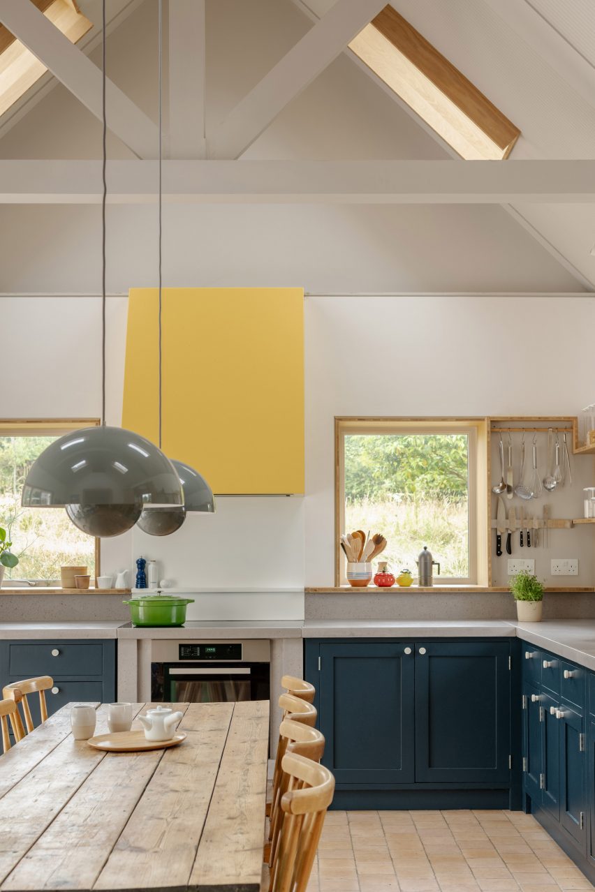 Kitchen with yellow extraction hood