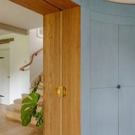 Curved wooden wall with secret drinks cabinet