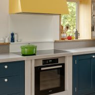 Oversized yellow extraction hood above cooker