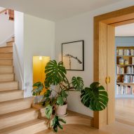 Hallway with wooden staircase and wall cutout