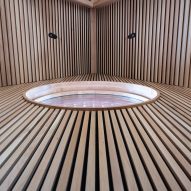 Circular window cutout in timber-clad wall