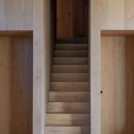 Staircase cut into oak-lined wall