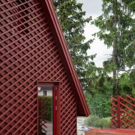 Red house extension next to forest