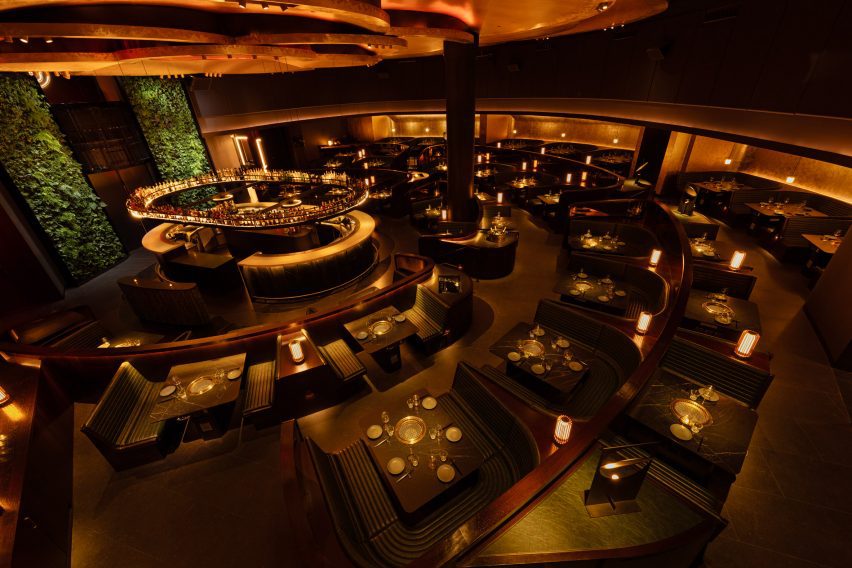 Restaurant interior viewed from overhead, showing tables are arranged around a bar like an amphitheatre
