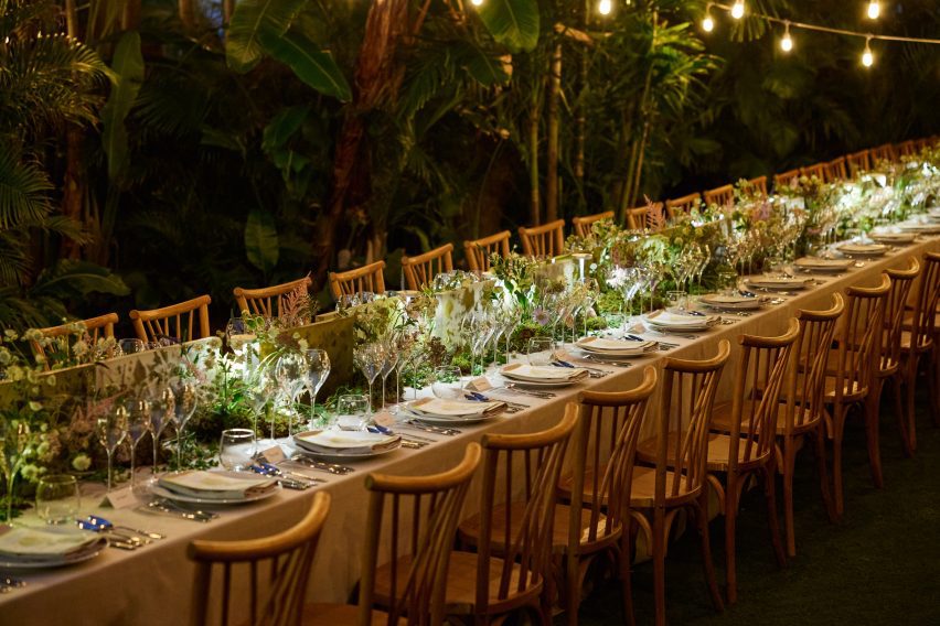 Long dinner table set within tropical foliage for Perrier-Jou&euml;t&rsquo;s Banquet of Nature event