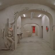 Arms and legs protrude from catacomb-like bar interior in Rome