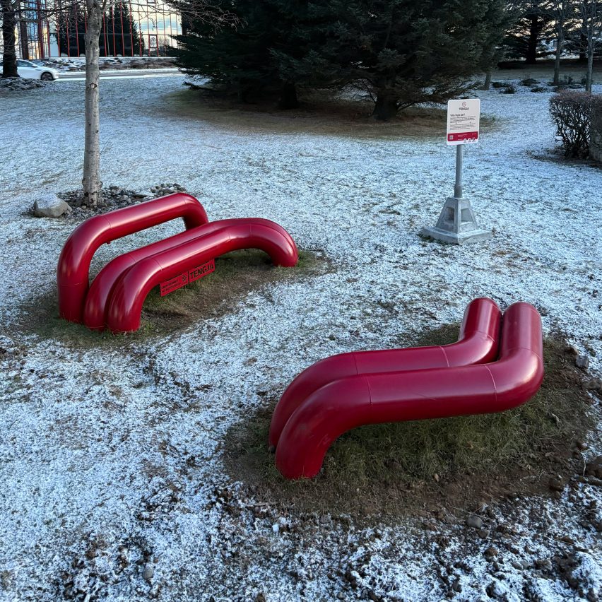 a photo of red park benches
