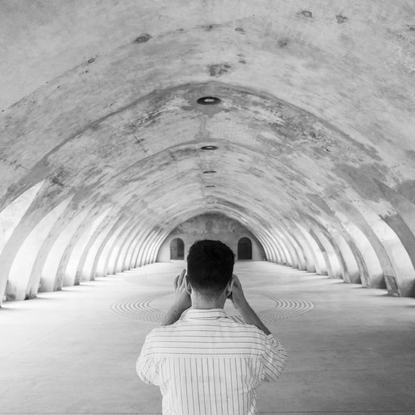 a person taking a photograph in a tunnel