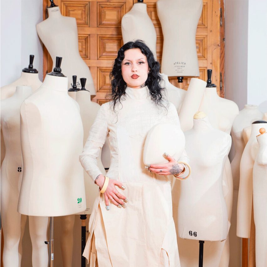 a person holding the head of a mannequin