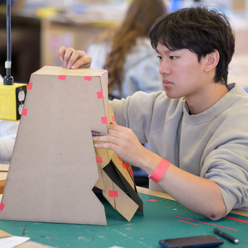 a student making a cardboard model