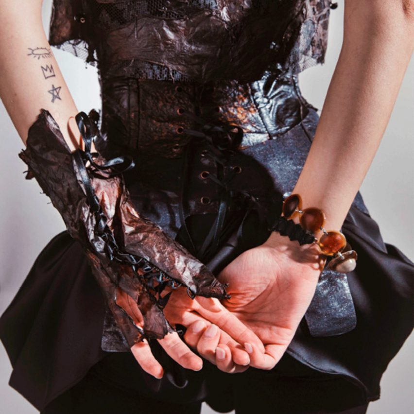 a photograph of a person's hands behind their back