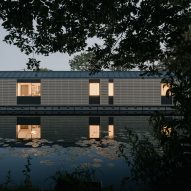 Night view of facade of Float House by TiggColl