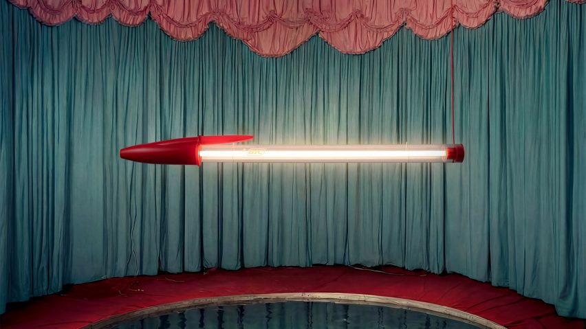 Pen-shaped lamp hanging in curtained room
