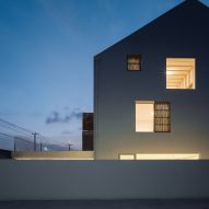 Rural guesthouse with windows lit up at night
