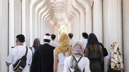 a group of people walking through a corridor