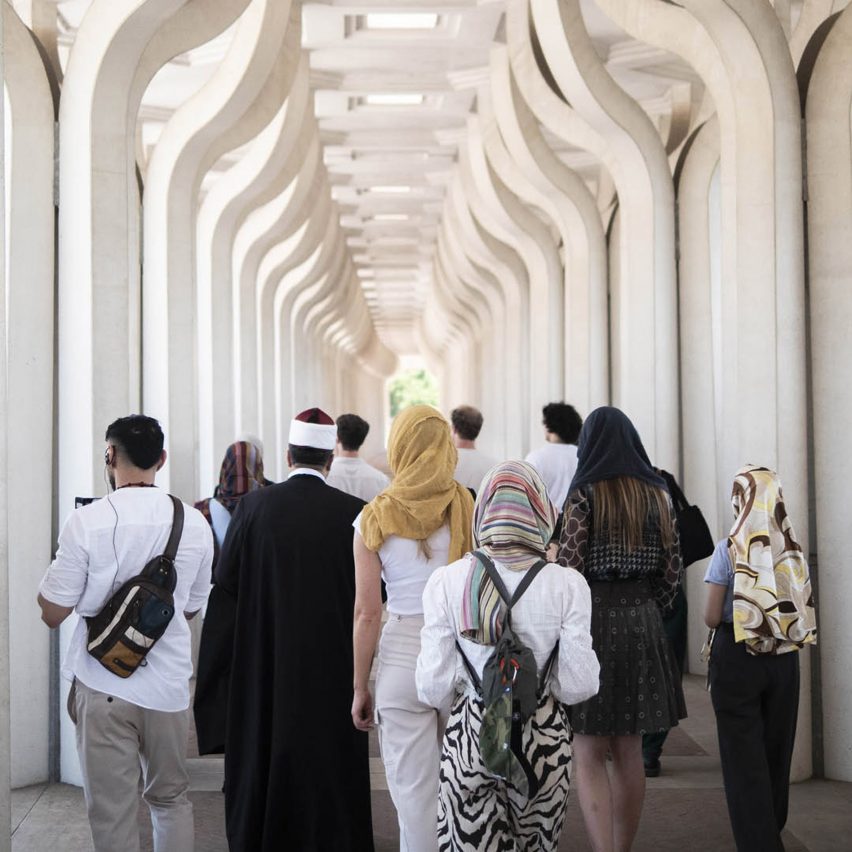 a group of people walking through a corridor