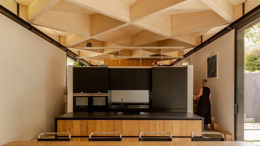 Kitchen with exposed timber diagrid roof in Arbour House by Andrei Saltykov