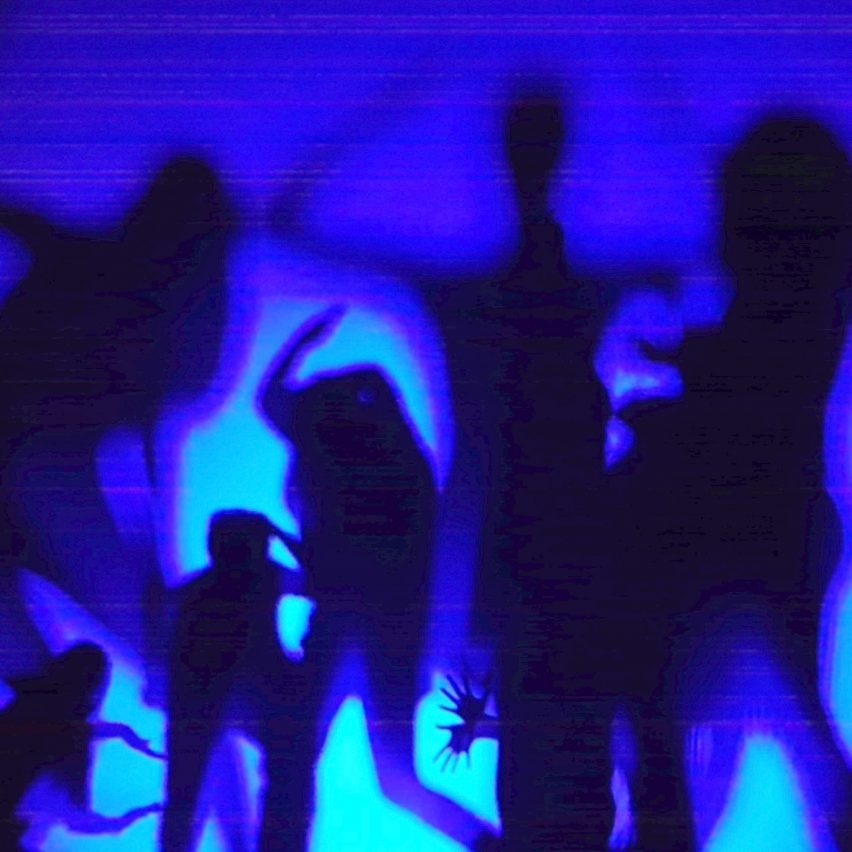 silhouettes of people against a blue backdrop