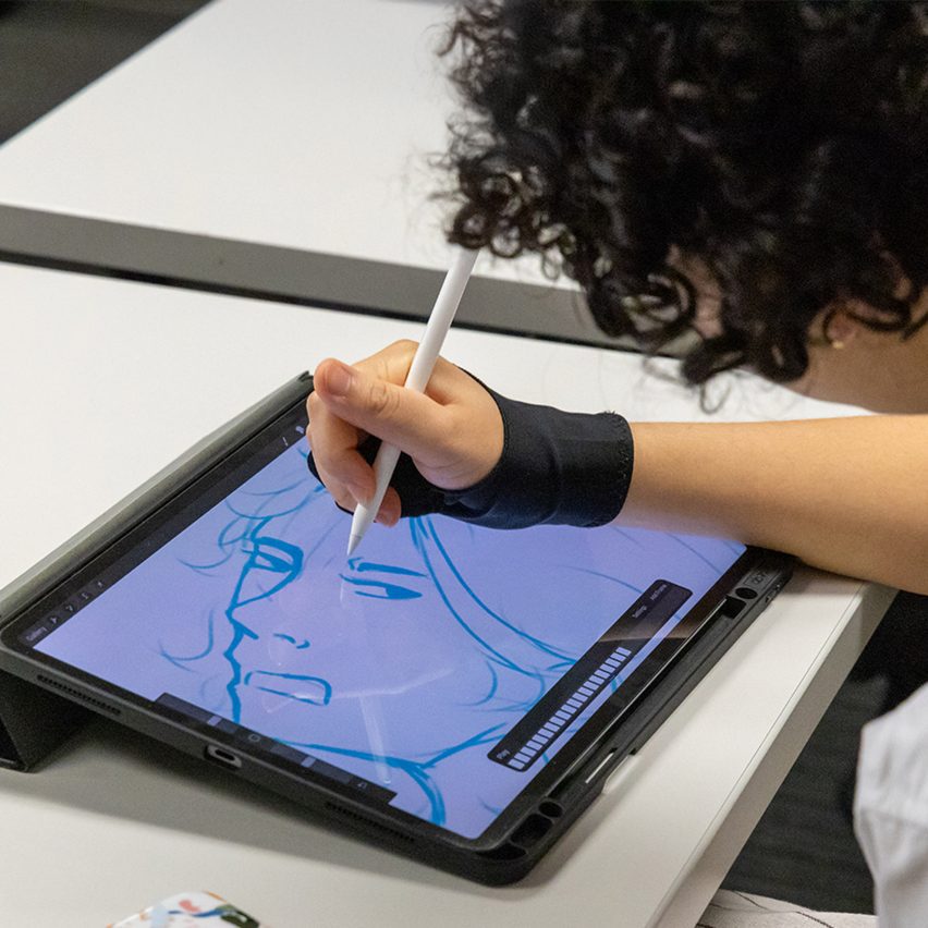 person drawing on a tablet