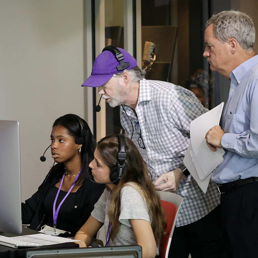 people gathered around a computer screen