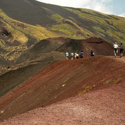 Landscape with people walking over a hilltop