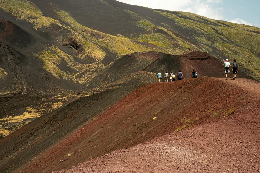 Landscape with people walking over a hilltop