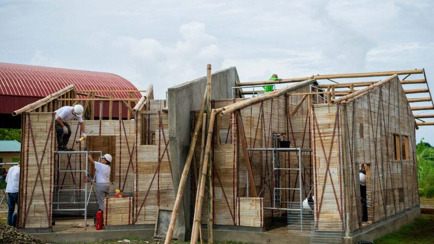People building a house from bamboo