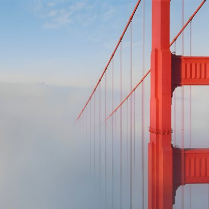 an image of a red bridge within clouds