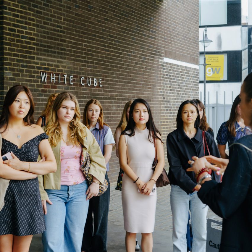 people standing outside white cube gallery