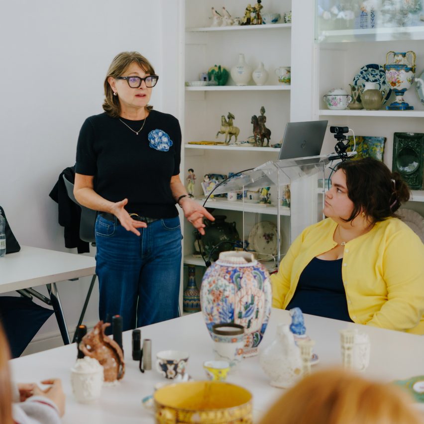 person speaking in room filled with art pieces