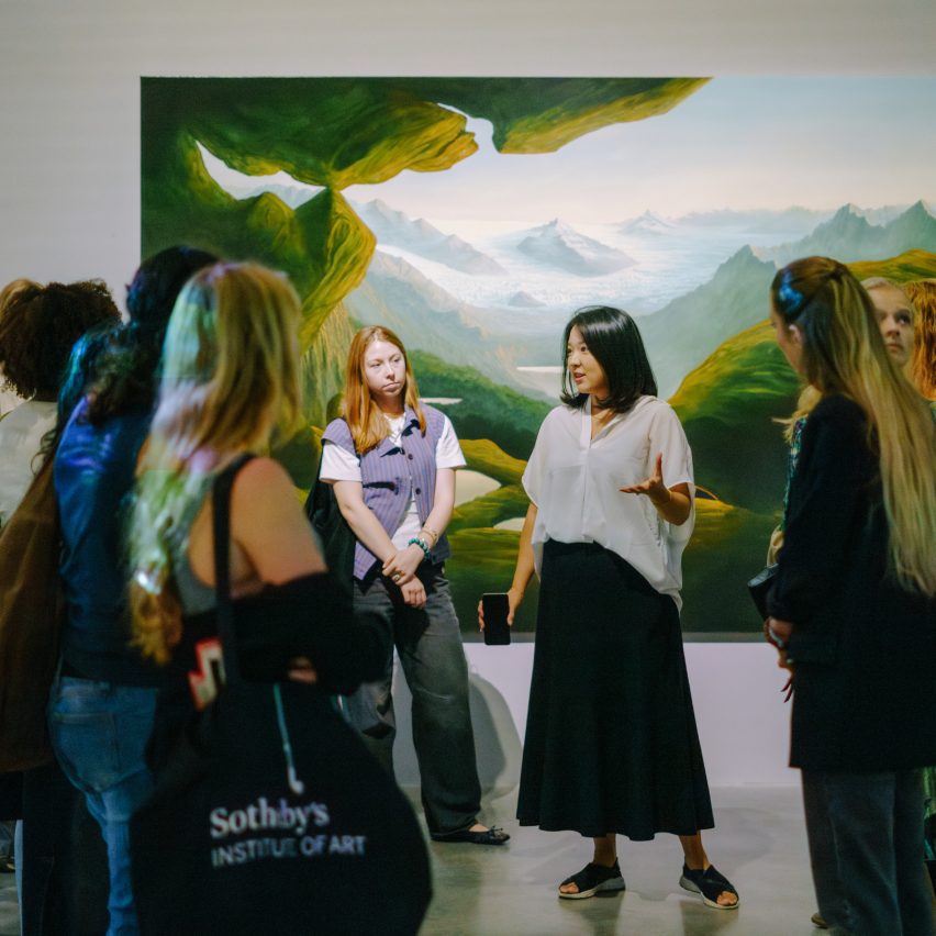 people standing in front of artwork in a gallery