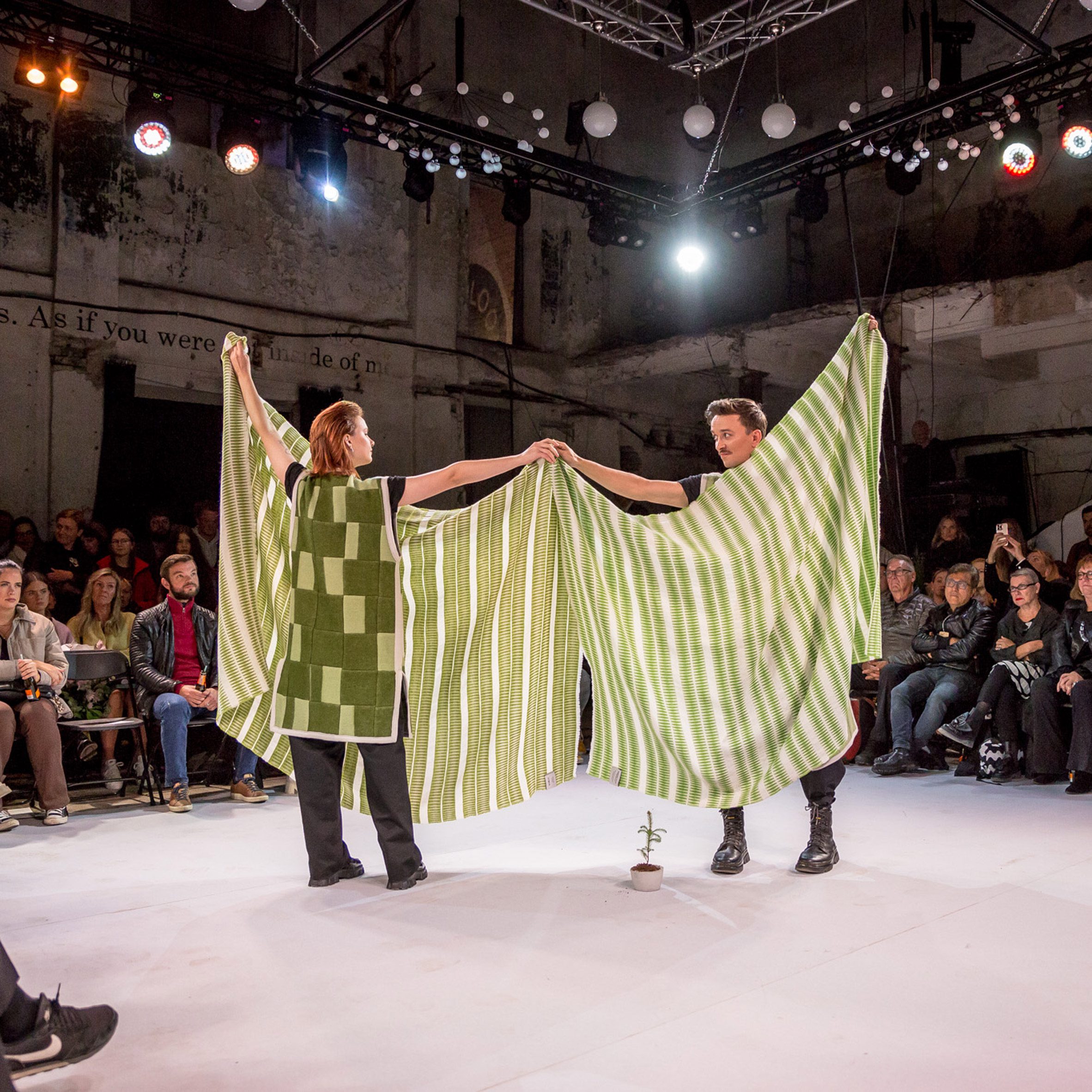 Photo of two people wearing and holding fabric