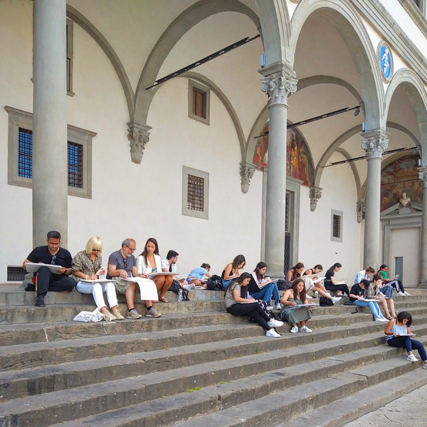 students sat on steps of a building