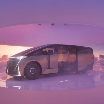 Person stands in a mist-filled circular space facing a six-wheeled Lexus Concept vehicle