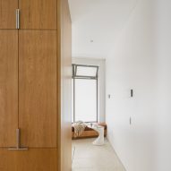 Kitchen cupboards next to small sitting room
