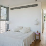 White bedroom with glass brick wall