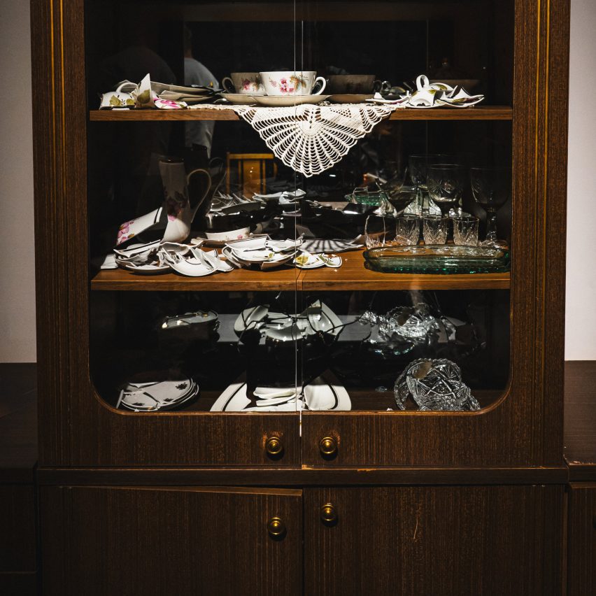a photograph of a wooden cabinet with objects inside