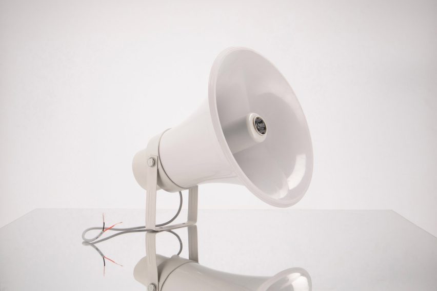 Image of a white speakerphone against a white background.