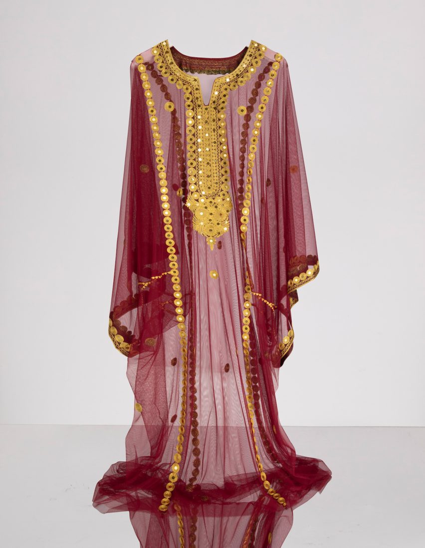 A photography of a hanging, decorative piece of clothing.