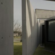 Casa Alba by Ademas Arquitectura, a concrete house with a wall for privacy