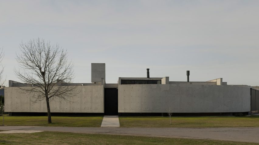 Casa Alba by Ademas Arquitectura, a concrete house with a wall for privacy