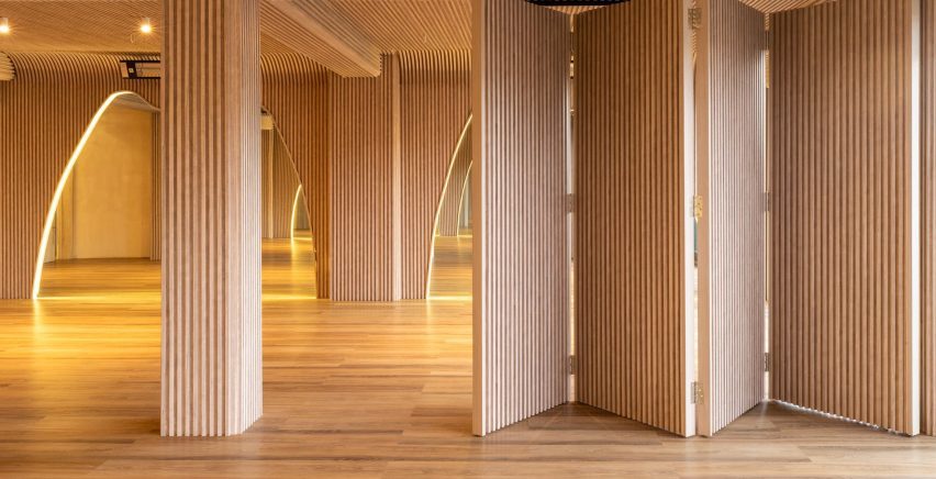 Bi-fold partitions allow yoga studio to be divided as needed