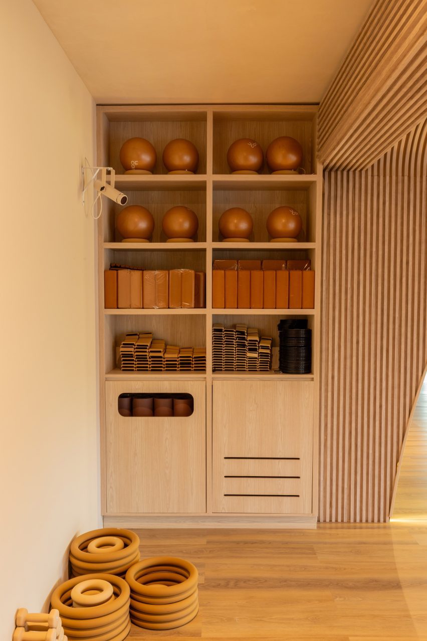 Light-toned oak shelves provide storage for yoga equipment